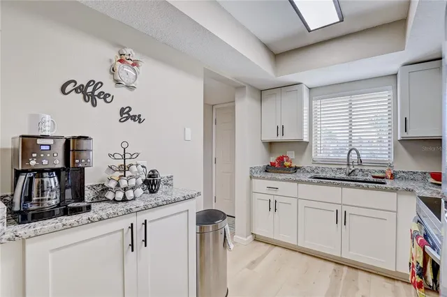 a kitchen with a sink and cabinets