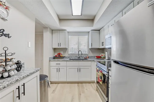 a kitchen with sink cabinets and appliances