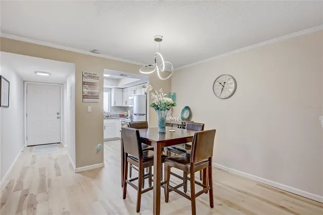 a view of a dining room with furniture wooden floor and a clock