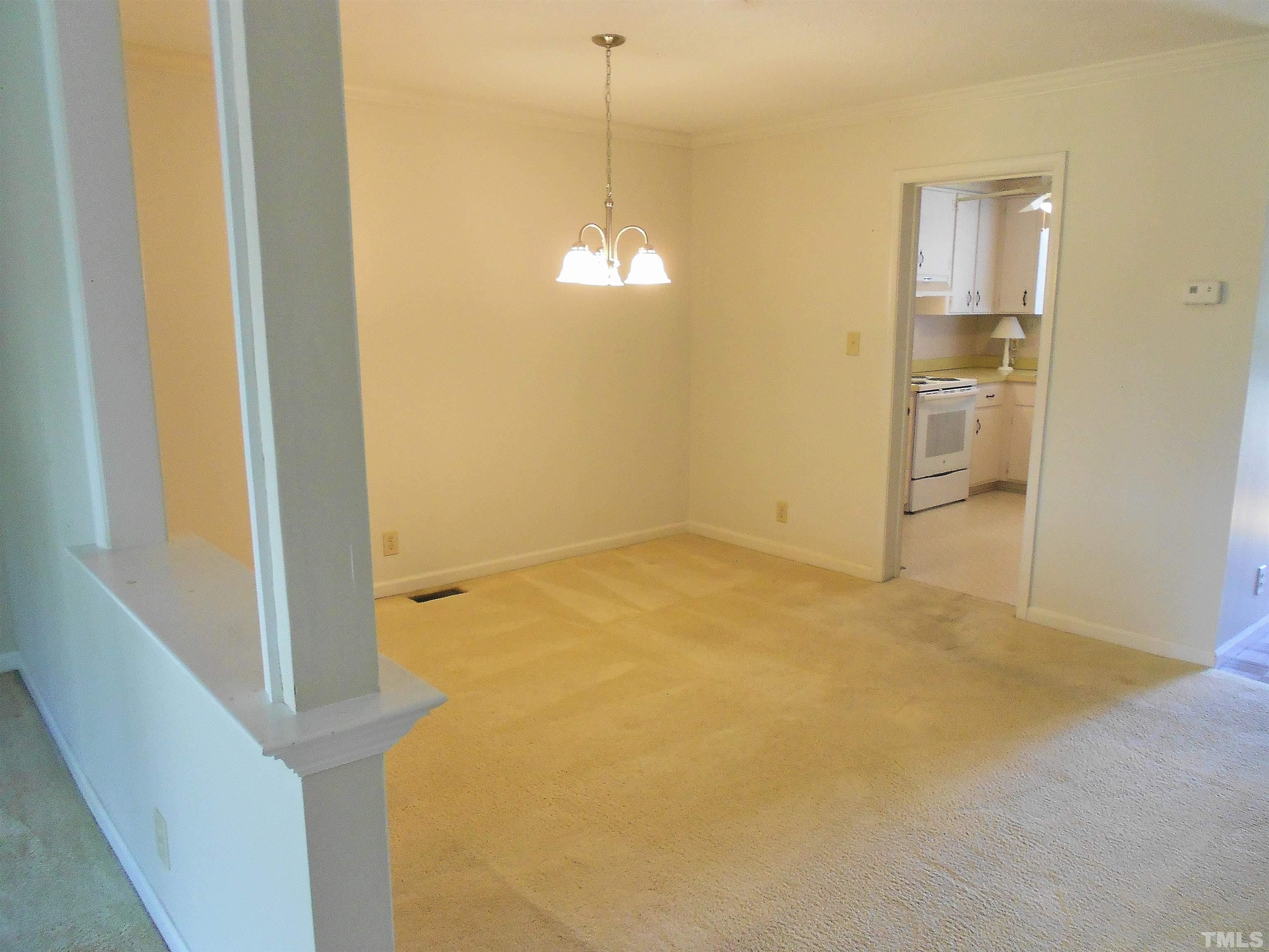3041 Wycliff Road Raleigh, NC 27607 - Photo 8 of 25 a view of a room with wooden floor and a ceiling fan
