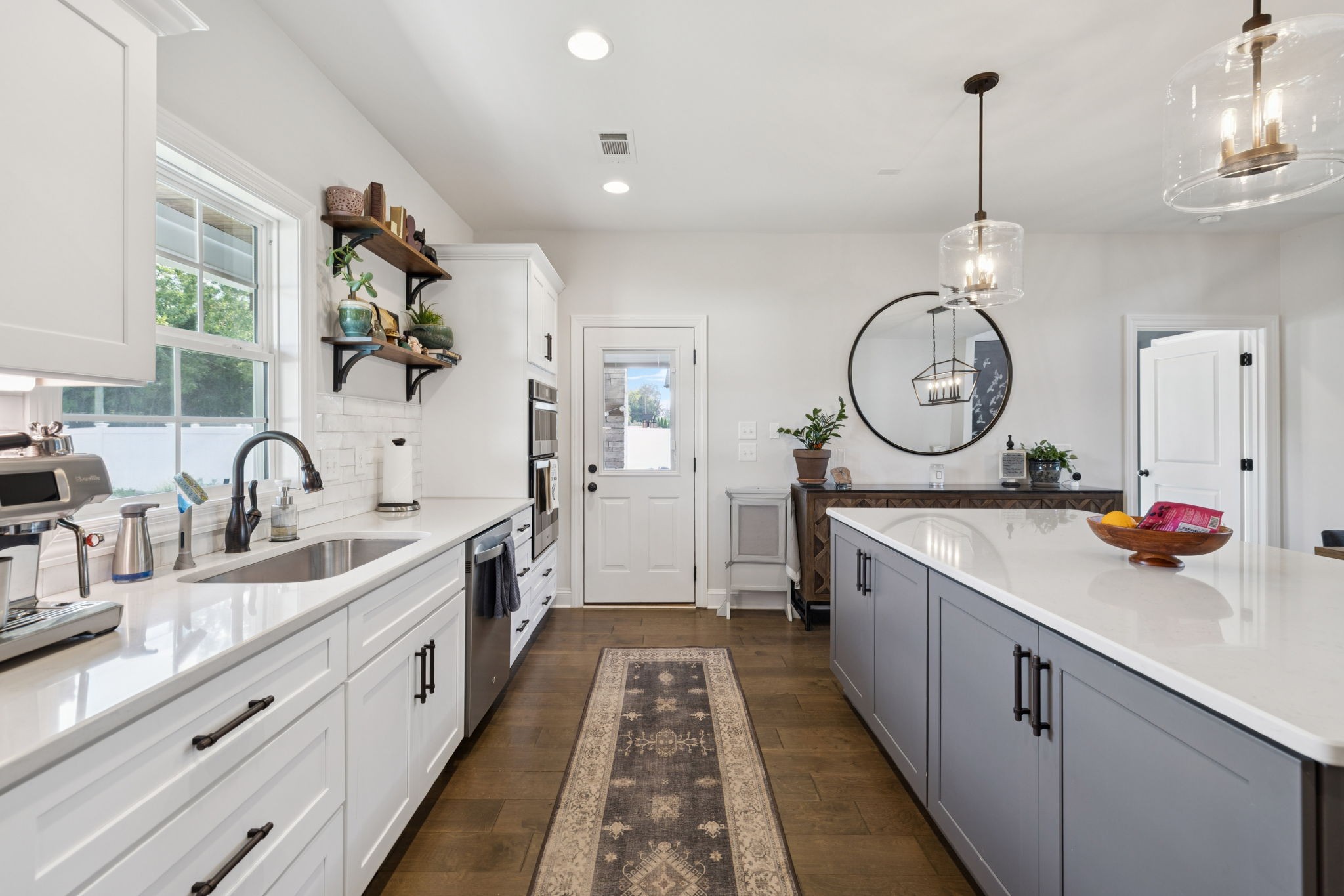 2022 Trout Trail Murfreesboro, TN 37129 - Photo 14 of 44 a large kitchen with kitchen island a stove a sink a refrigerator and a fireplace with wooden floor