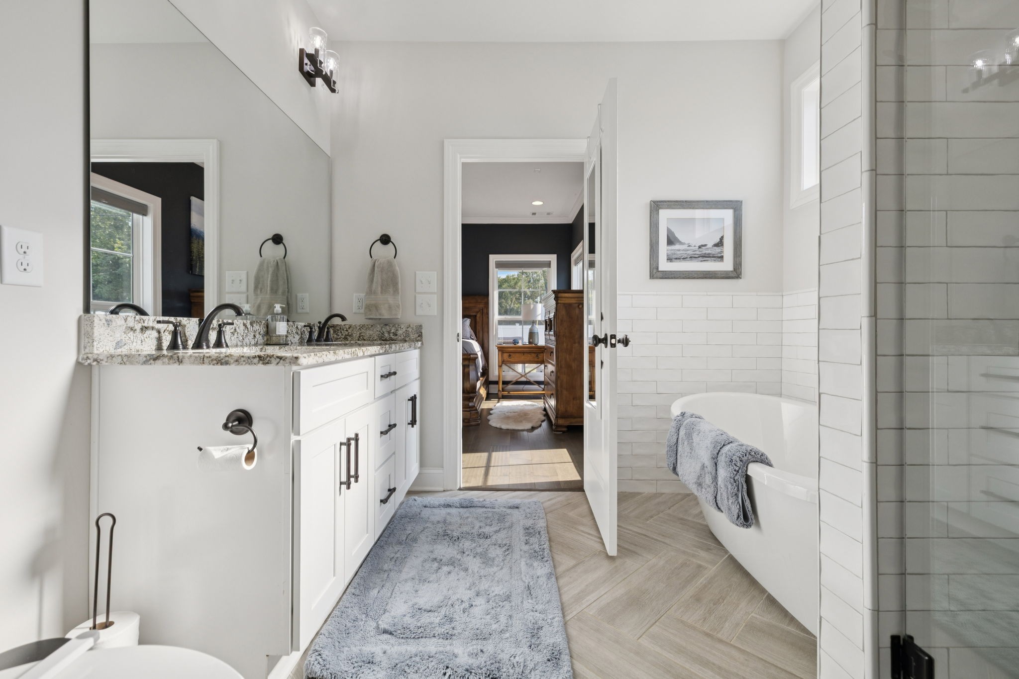 2022 Trout Trail Murfreesboro, TN 37129 - Photo 22 of 44 a bathroom with a double vanity sink a mirror and a bathtub