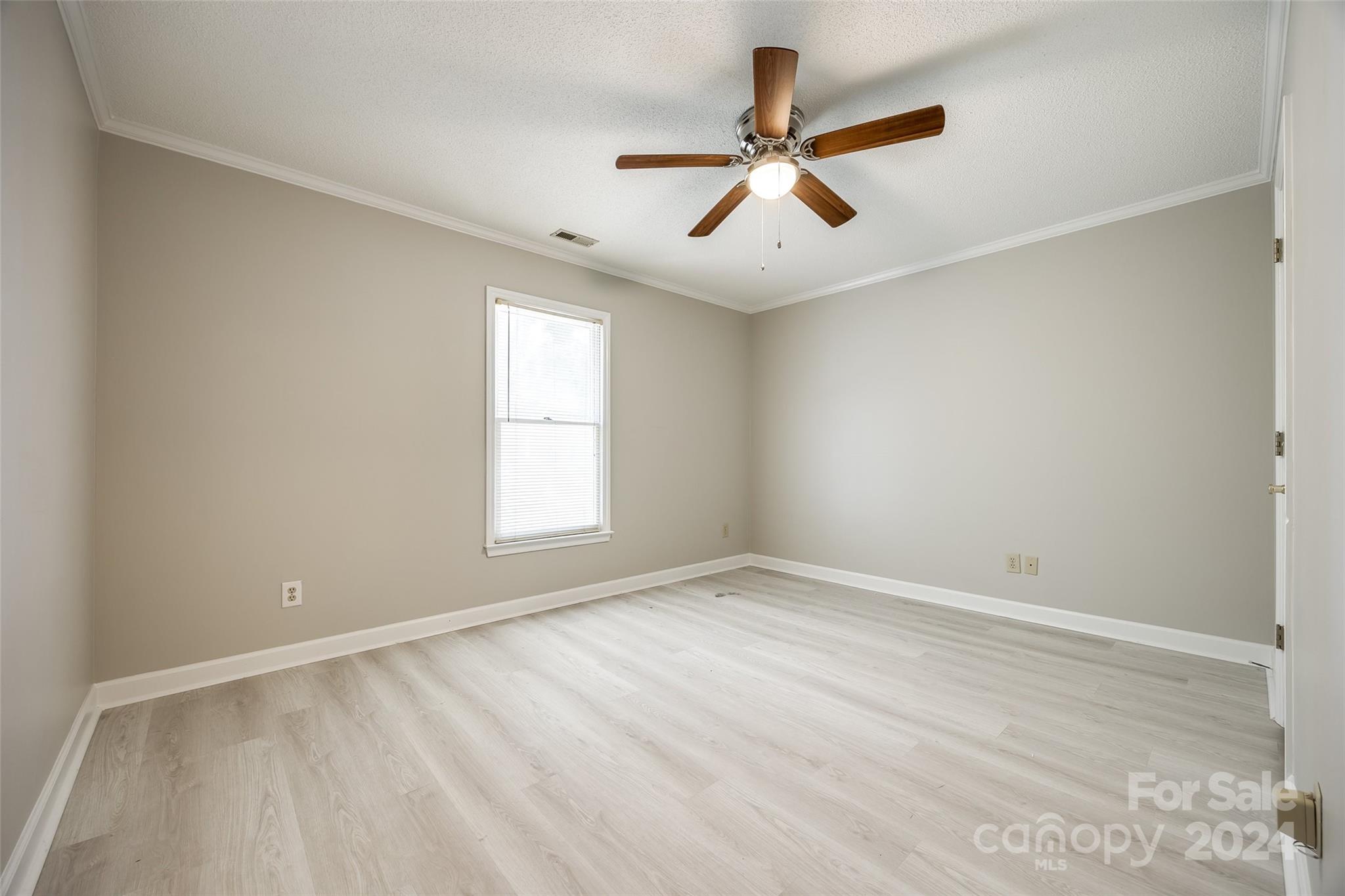 1711 Robinwood Road Gastonia, NC 28054 - Photo 16 of 25 an empty room with ceiling fan and windows