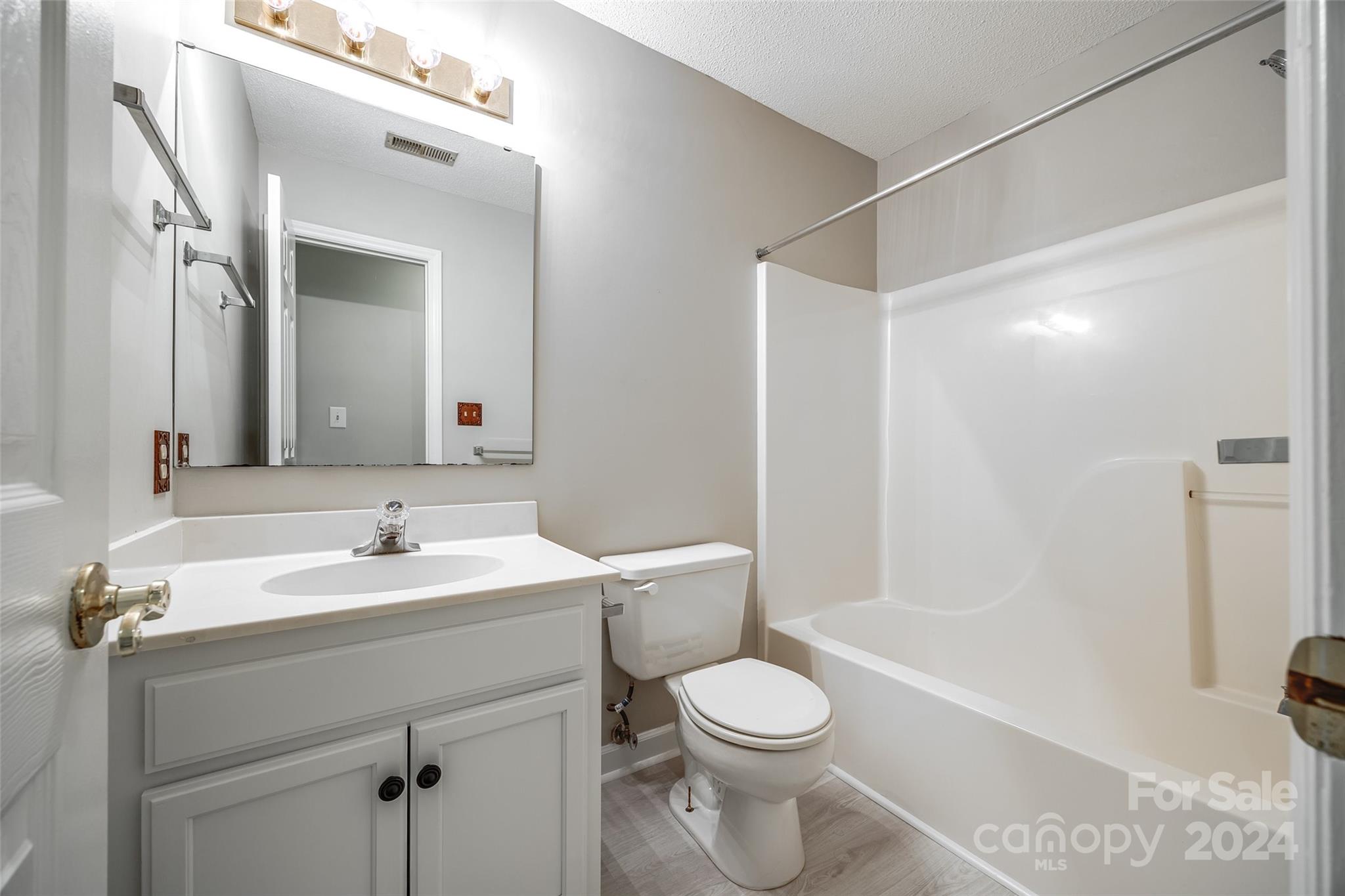 1711 Robinwood Road Gastonia, NC 28054 - Photo 18 of 25 a bathroom with a toilet a sink a mirror a shower a vanity and window