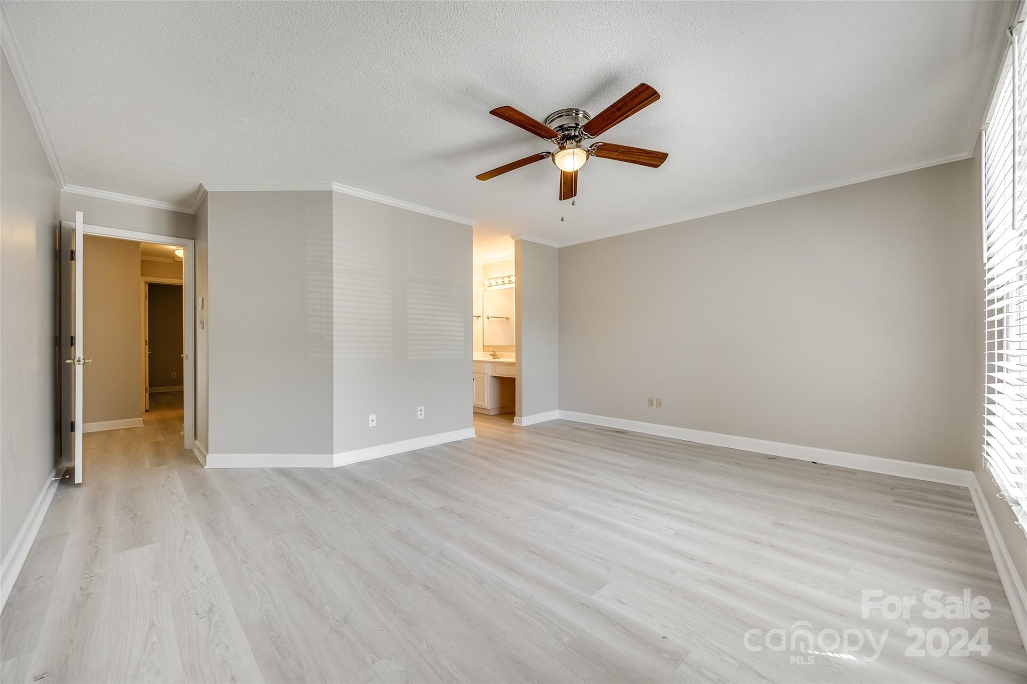 1711 Robinwood Road Gastonia, NC 28054 - Photo 20 of 25 a view of empty room with wooden floor and fan
