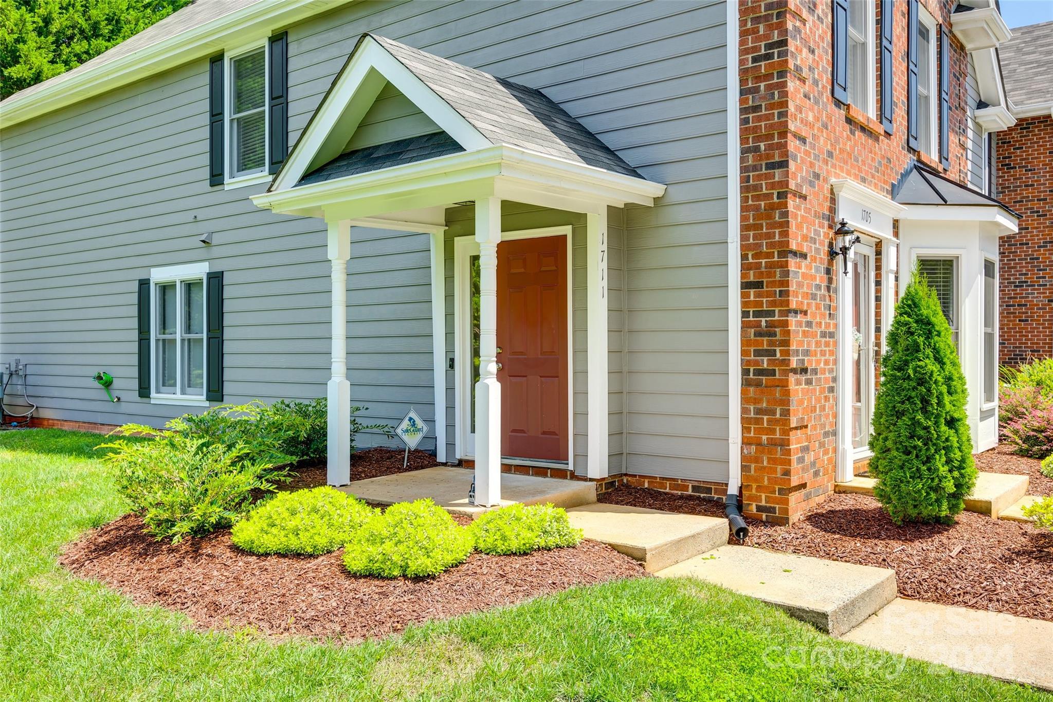 1711 Robinwood Road Gastonia, NC 28054 - Photo 2 of 25 a front view of a house with garden