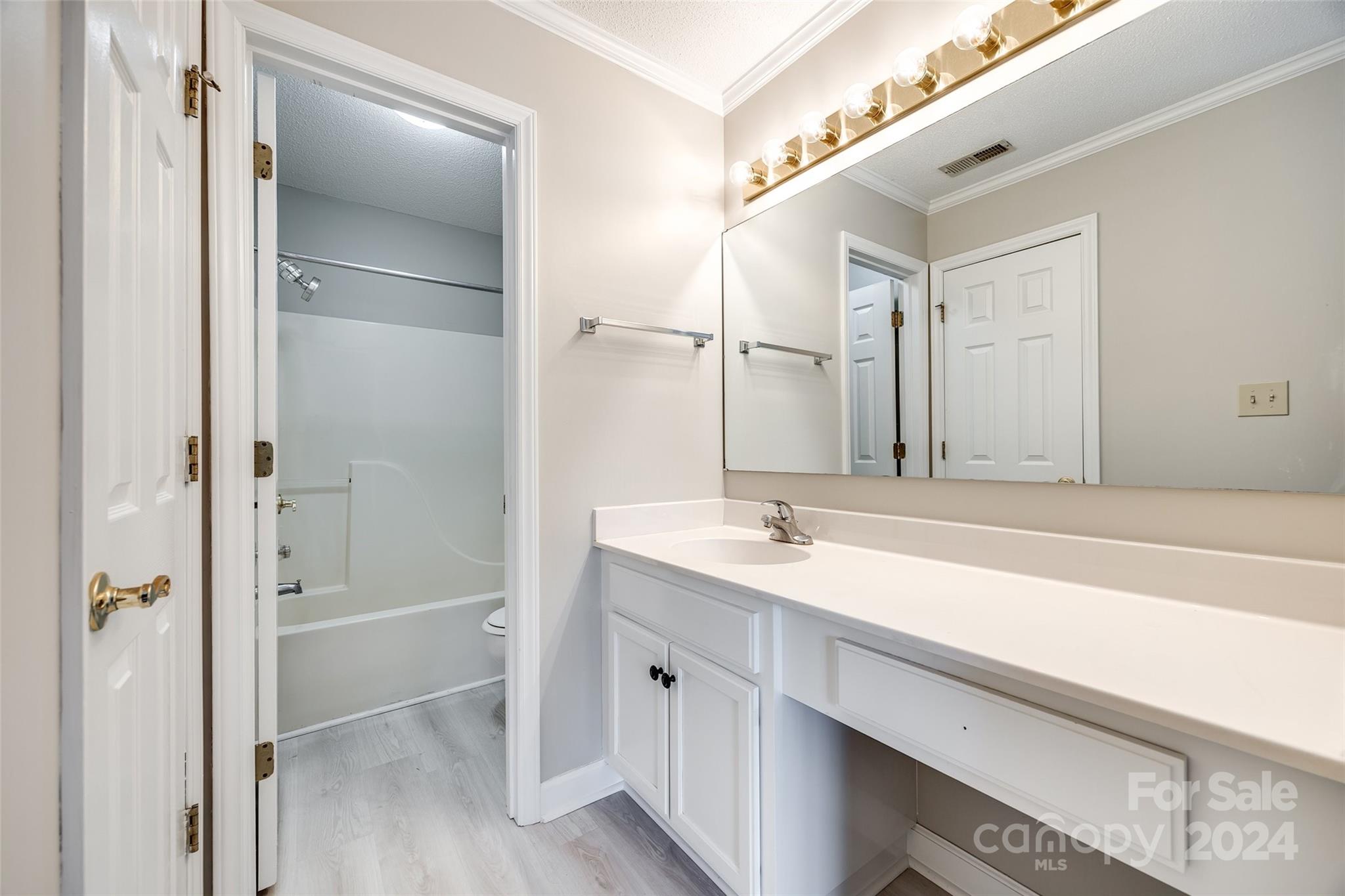 1711 Robinwood Road Gastonia, NC 28054 - Photo 22 of 25 a bathroom with a tub sink shower and a mirror
