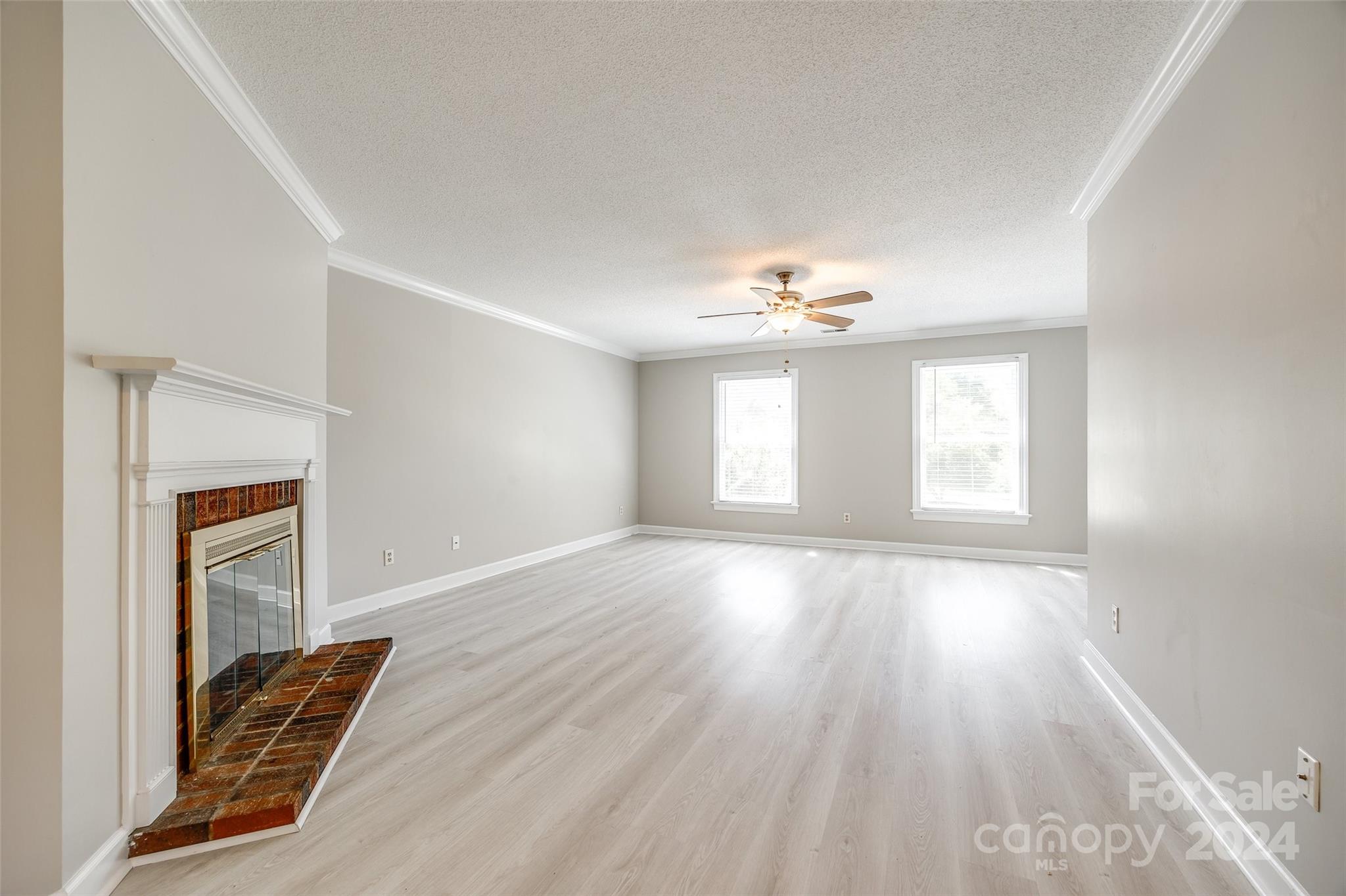 1711 Robinwood Road Gastonia, NC 28054 - Photo 5 of 25 a view of an empty room with wooden floor and a window
