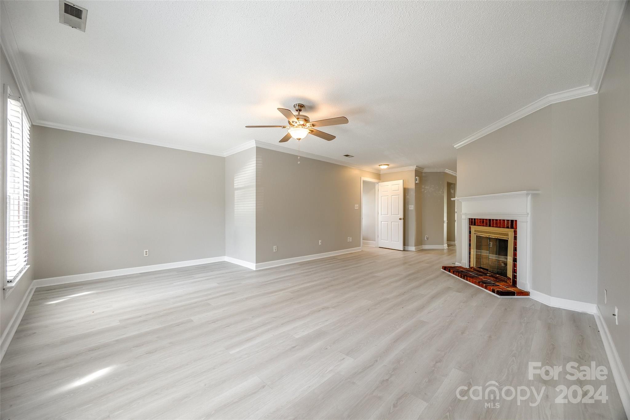 1711 Robinwood Road Gastonia, NC 28054 - Photo 6 of 25 an empty room with windows and a fireplace