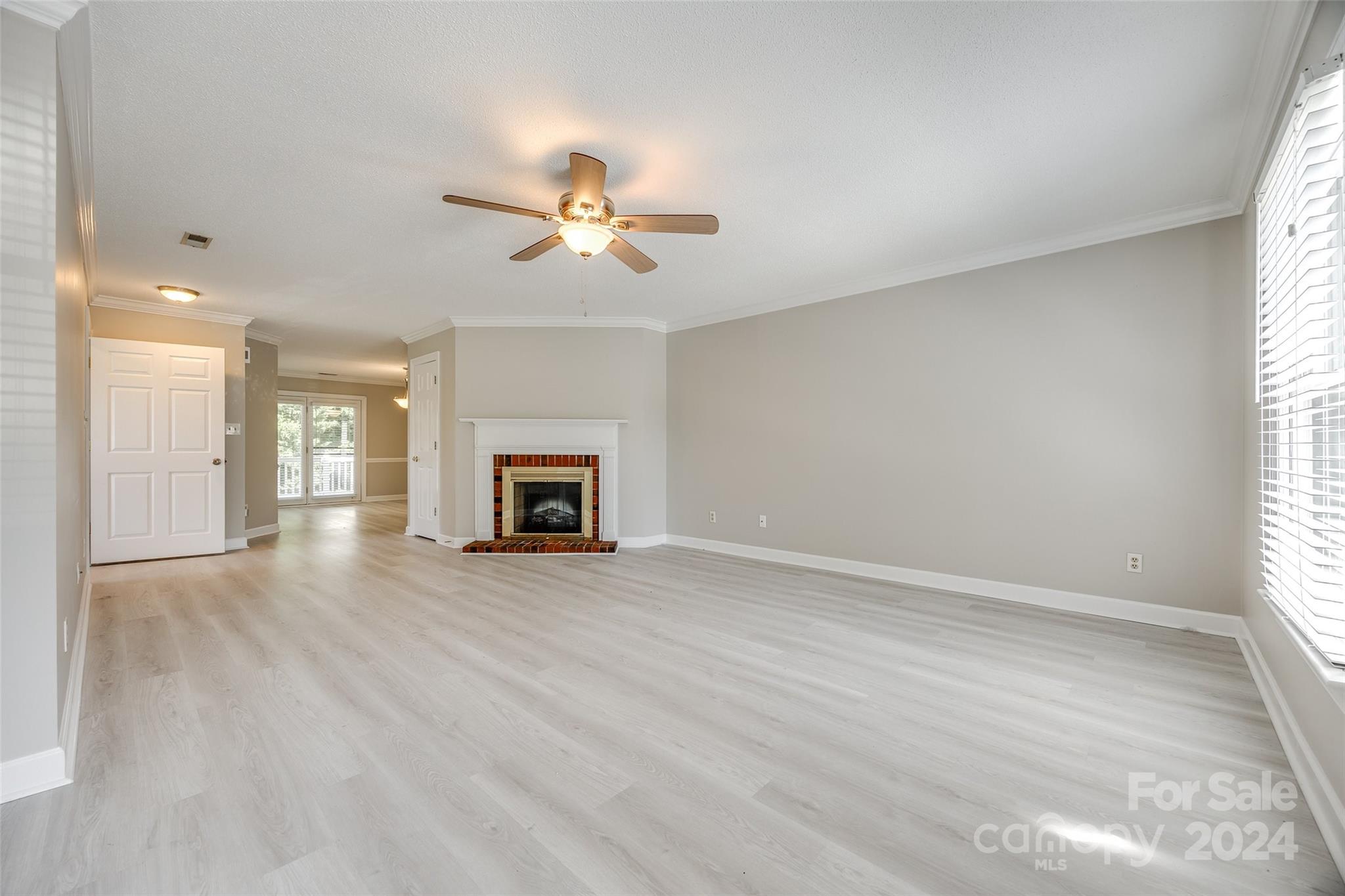 1711 Robinwood Road Gastonia, NC 28054 - Photo 7 of 25 an empty room with windows and a fireplace