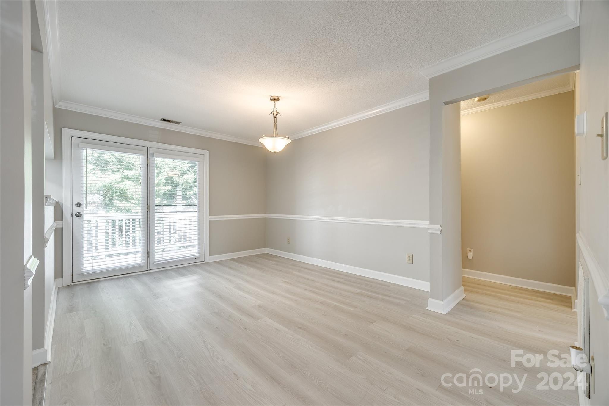 1711 Robinwood Road Gastonia, NC 28054 - Photo 9 of 25 a view of an empty room with wooden floor and a window