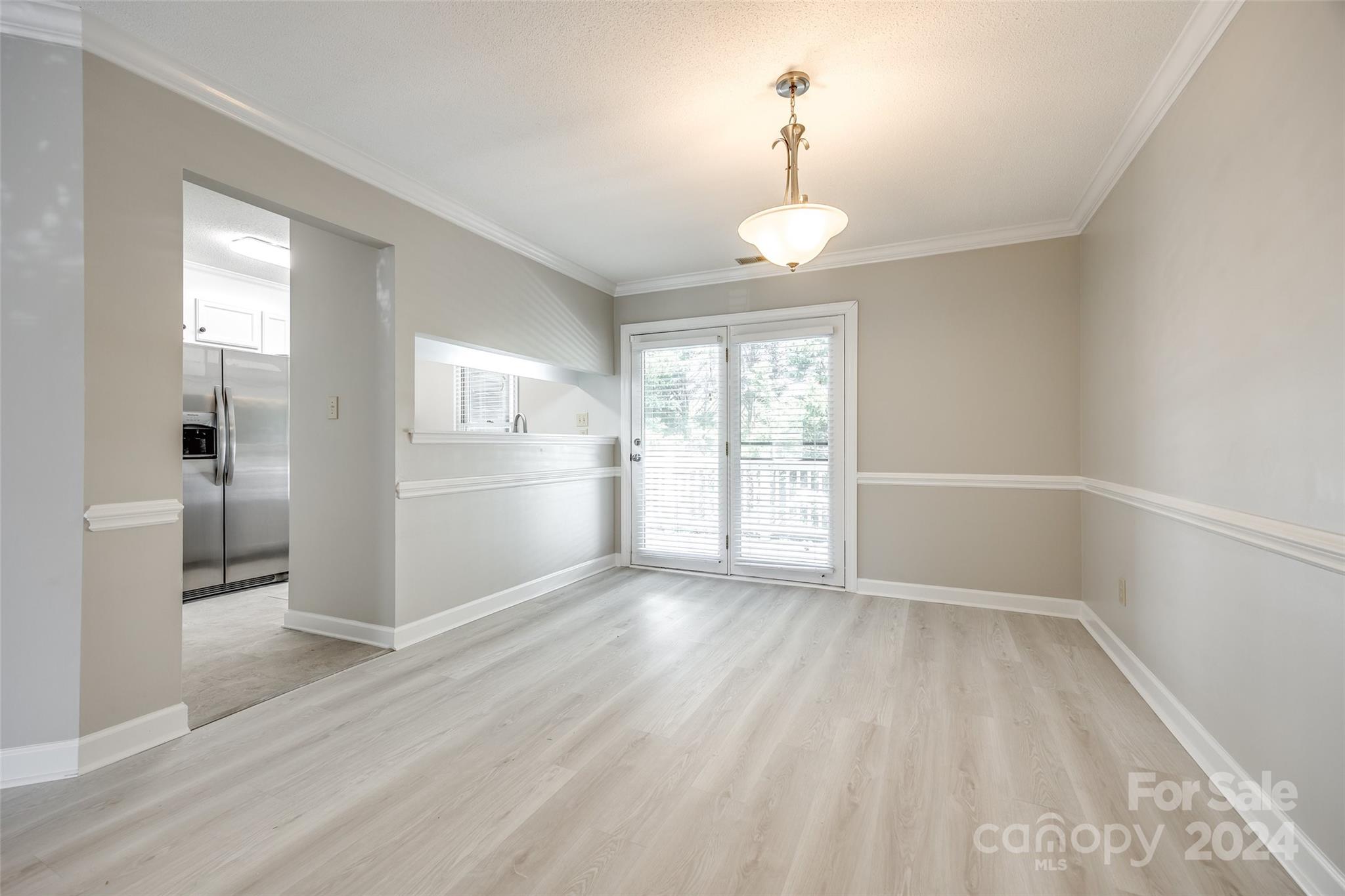 1711 Robinwood Road Gastonia, NC 28054 - Photo 10 of 25 a view of wooden floor and a chandelier in a room