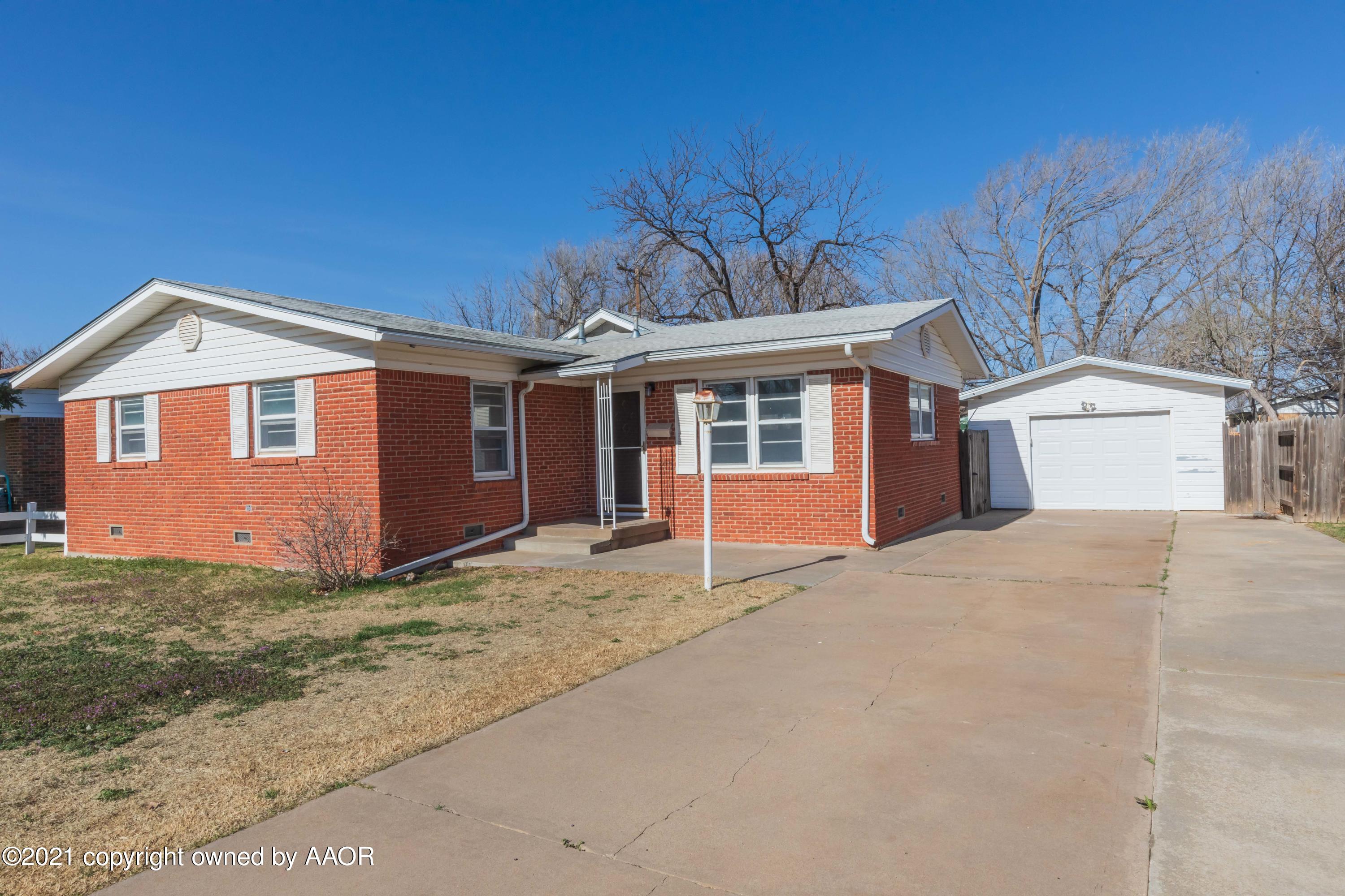 4702 South Rusk Street Amarillo, TX 79110 - Photo 1 of 36 a front view of a house with a garden and garage