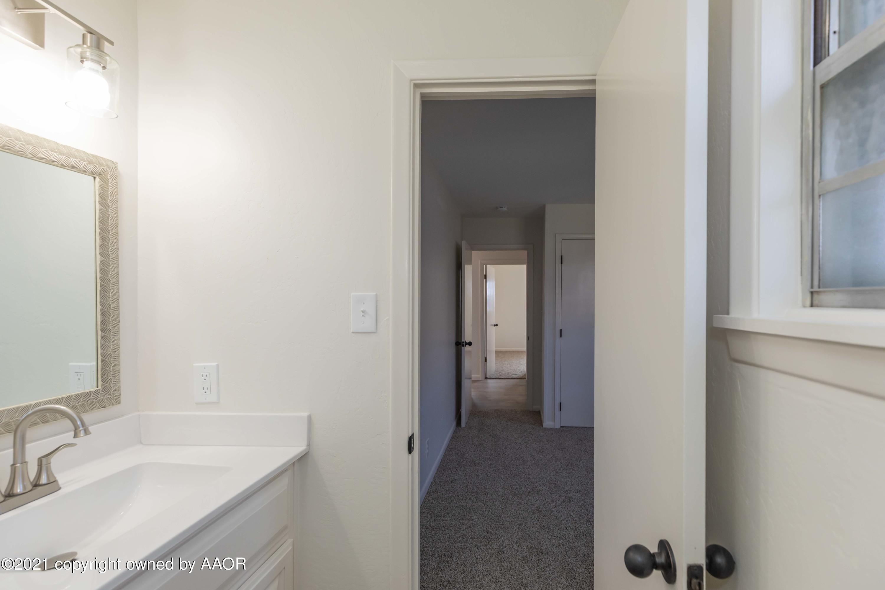 4702 South Rusk Street Amarillo, TX 79110 - Photo 21 of 36 a bathroom with a sink and a mirror