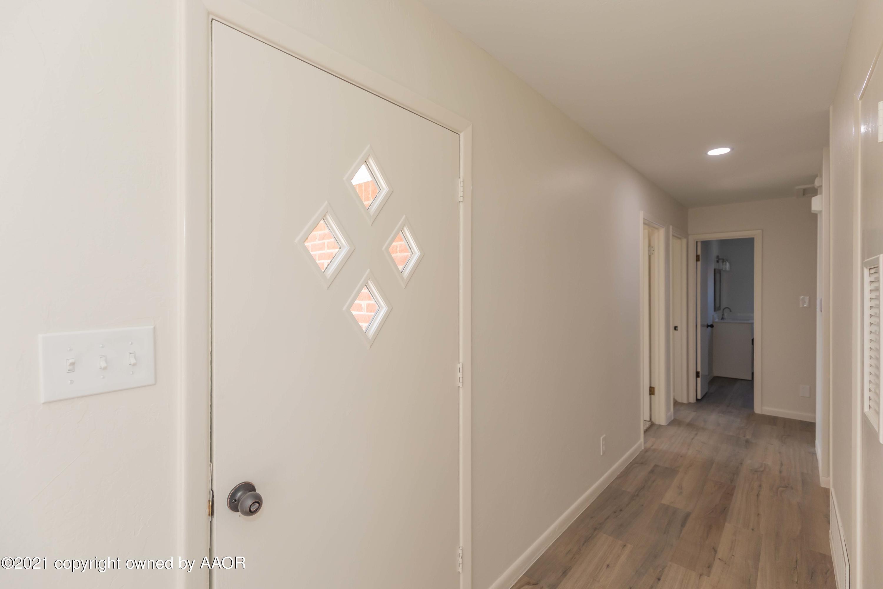 4702 South Rusk Street Amarillo, TX 79110 - Photo 4 of 36 a view of a hallway with wooden floor