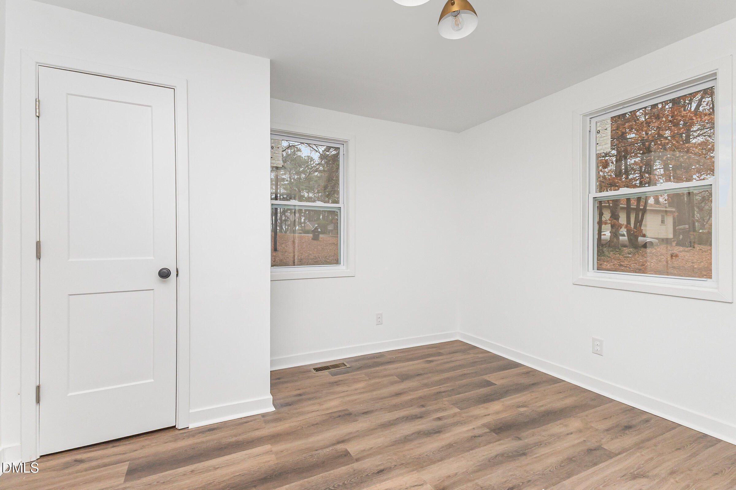 2506 Dominion Street Durham, NC 27704 - Photo 13 of 32 an empty room with wooden floor and windows