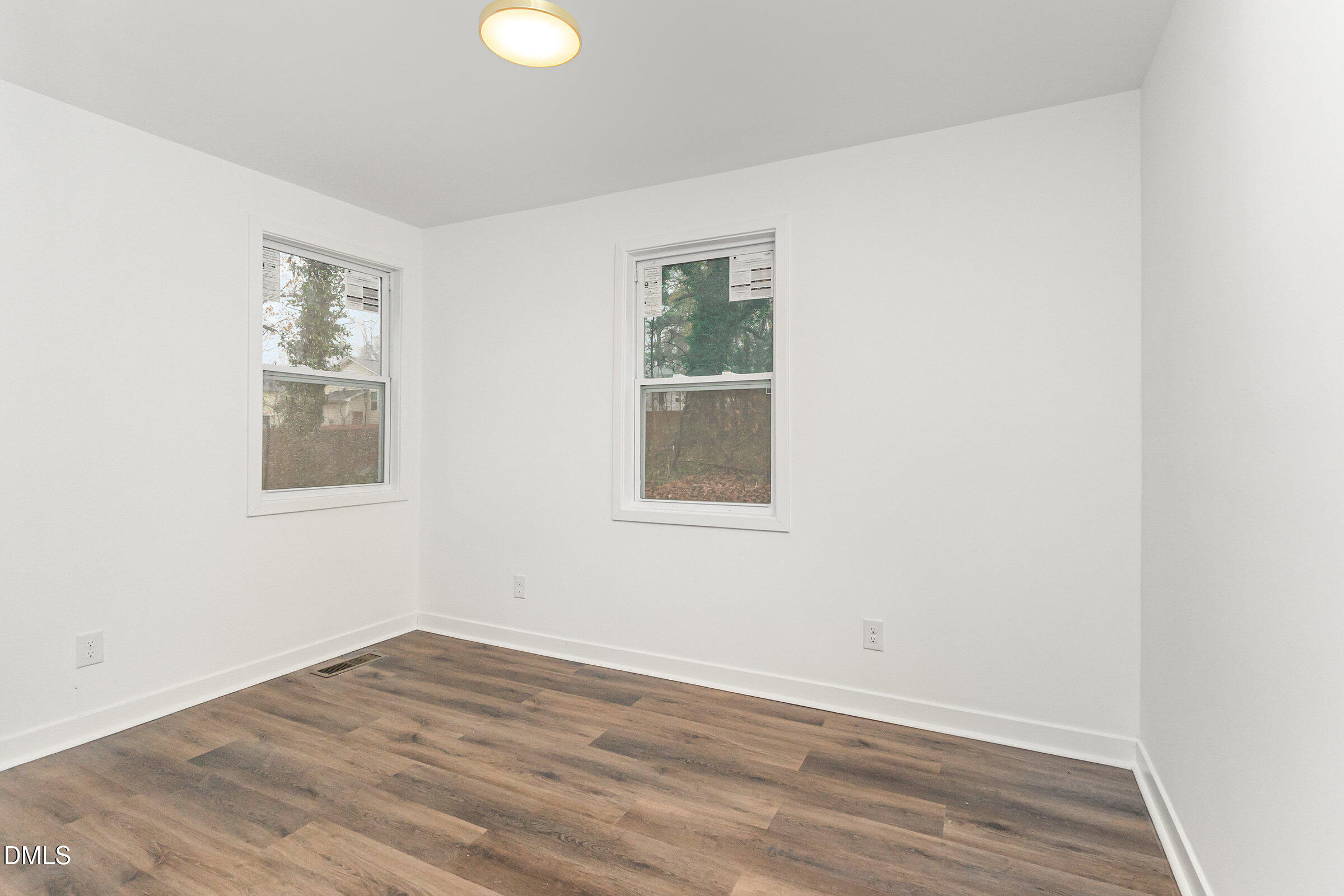 2506 Dominion Street Durham, NC 27704 - Photo 19 of 32 an empty room with wooden floor and windows