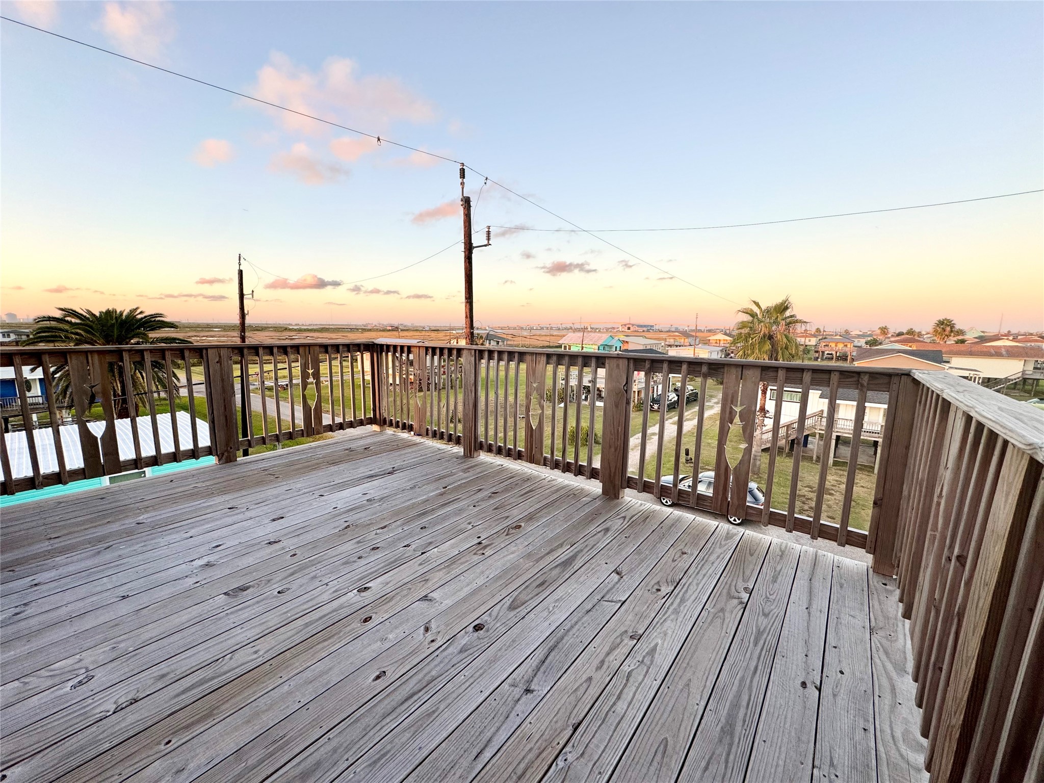 511 Caisson Street Surfside Beach, TX 77541 - Photo 26 of 33 a view of deck with wooden floor and fence with a lake view