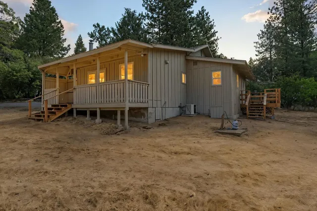 a backyard of a house with table and chairs
