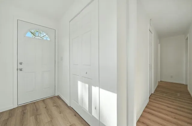 a view of a hallway with wooden floor