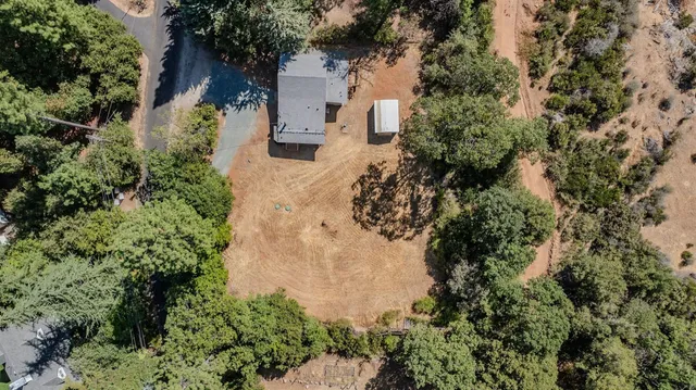 an aerial view of a house with a yard