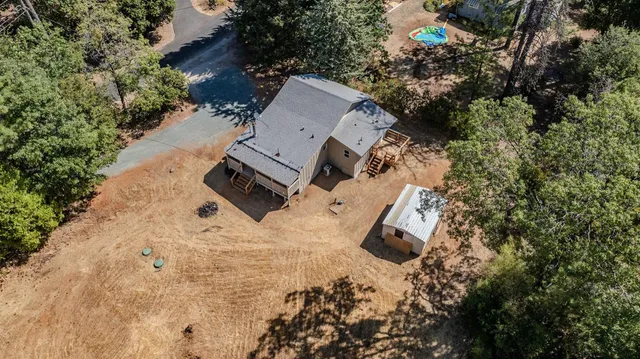 an aerial view of multiple houses with yard