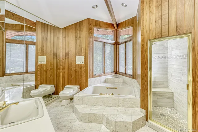 a bathroom with a bathtub and a shower