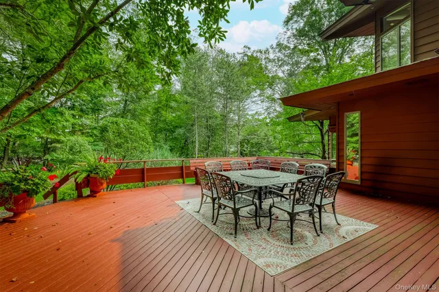 a patio with wooden floor and outdoor seating