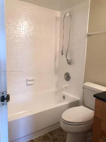 a bathroom with a toilet and a bathtub