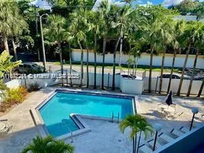 a view of a swimming pool with a patio and garden
