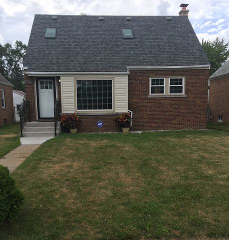 a brick house with a yard