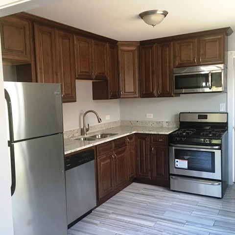 1530 State Line Road Calumet City, IL 60409 - Photo 7 of 16 a kitchen with stainless steel appliances granite countertop a refrigerator stove a sink dishwasher and microwave with wooden cabinets