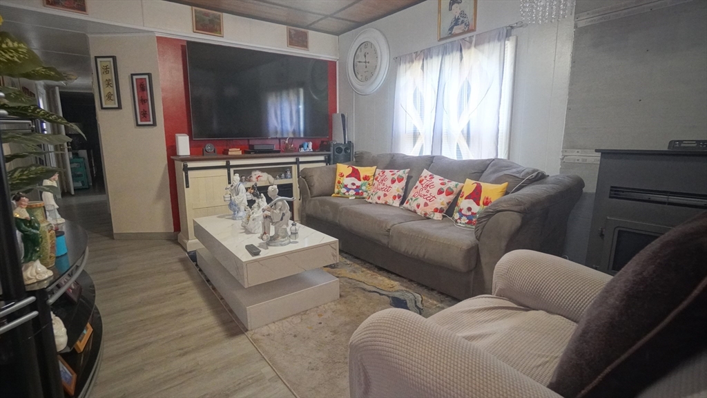 93 Grochmal Avenue, Unit 126 Springfield, MA 01151 - Photo 16 of 35 a living room with furniture and a flat screen tv