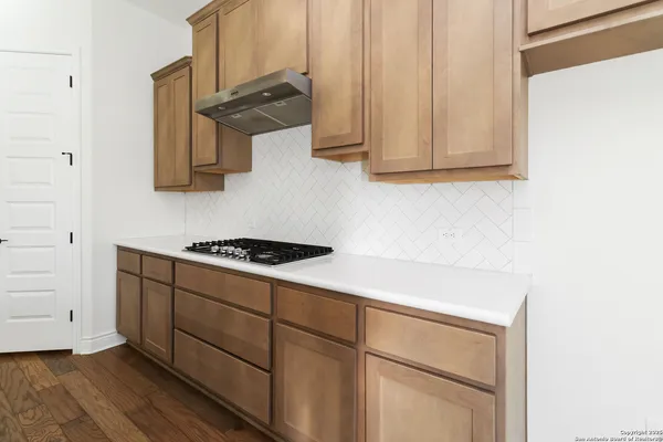 a kitchen with cabinets and appliances