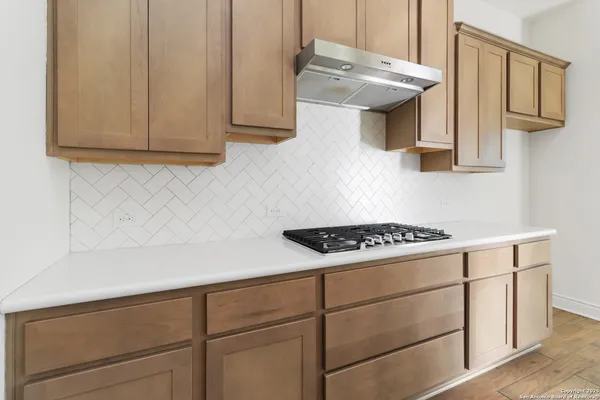 a kitchen with cabinets and a stove