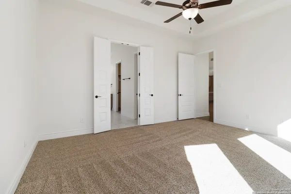 a view of a livingroom with a ceiling fan and window