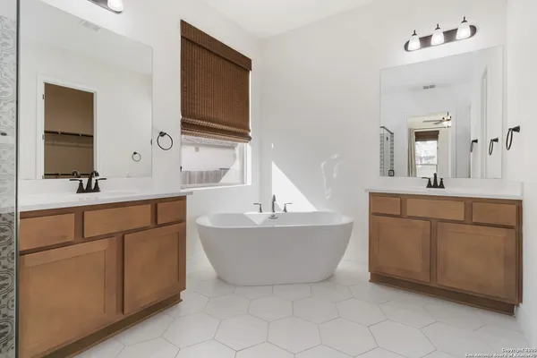 a bathroom with a sink mirror and a bathtub