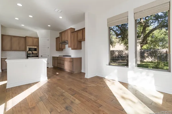 a large kitchen with stainless steel appliances a large window a oven and a large window