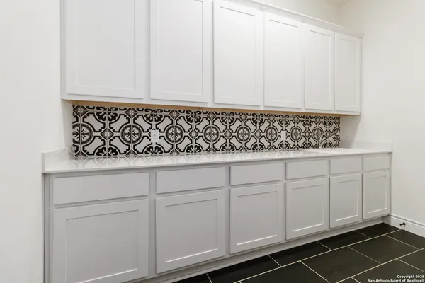 a close view of a sink and cabinets