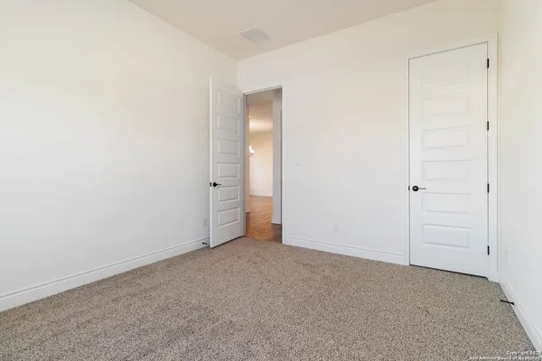 an empty room with closet area