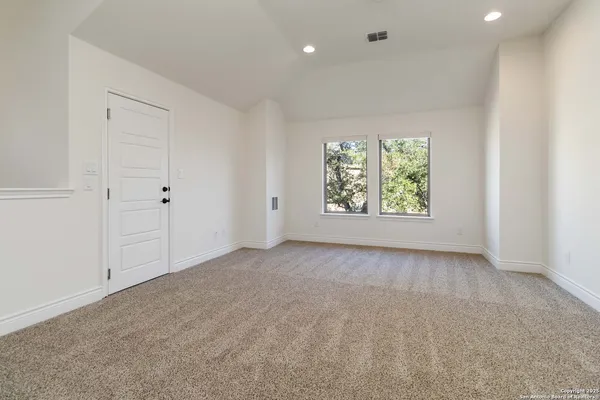 an empty room with windows and mountain view