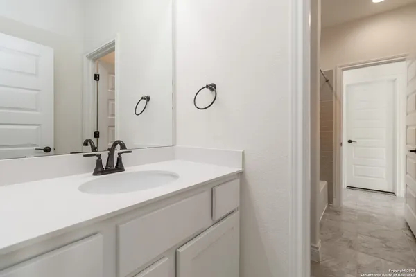 a bathroom with a white bath tub and a shower