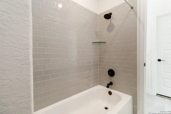 a bathroom with a bathtub and a sink