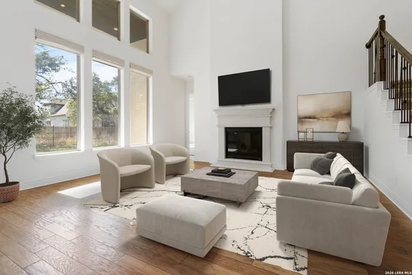 a living room with furniture a flat screen tv and a fireplace