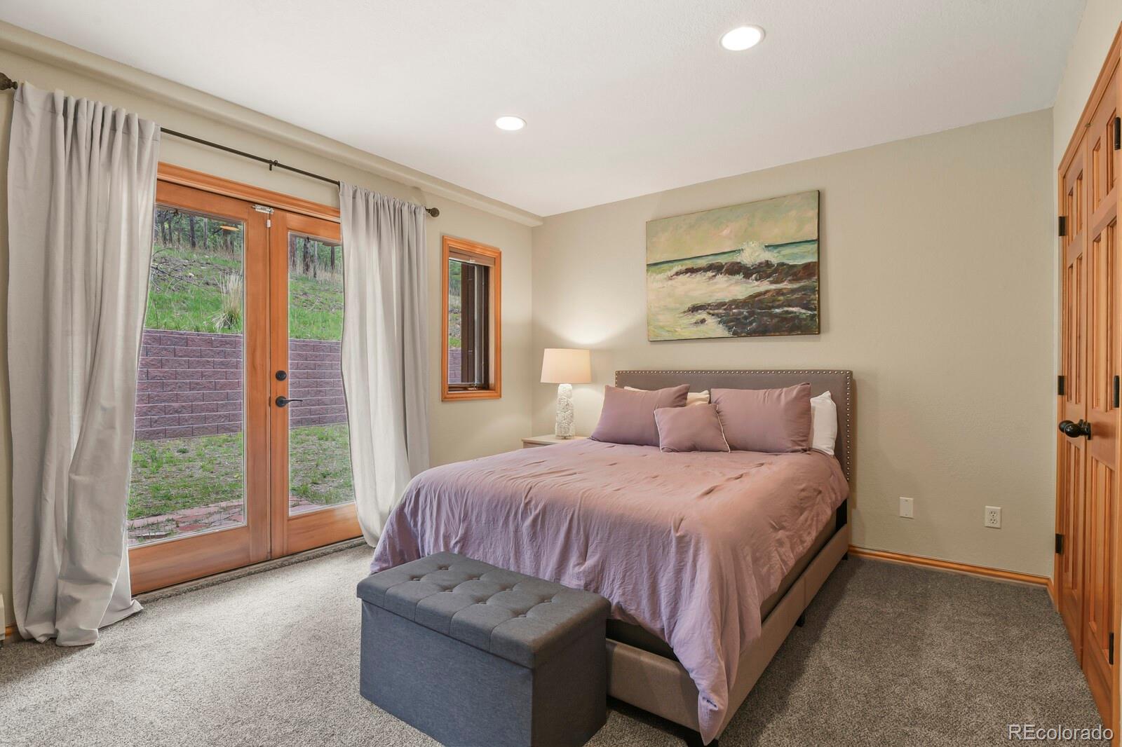 417 Witter Gulch Road Evergreen, CO 80439 - Photo 38 of 50 a bedroom with a bed and a large window