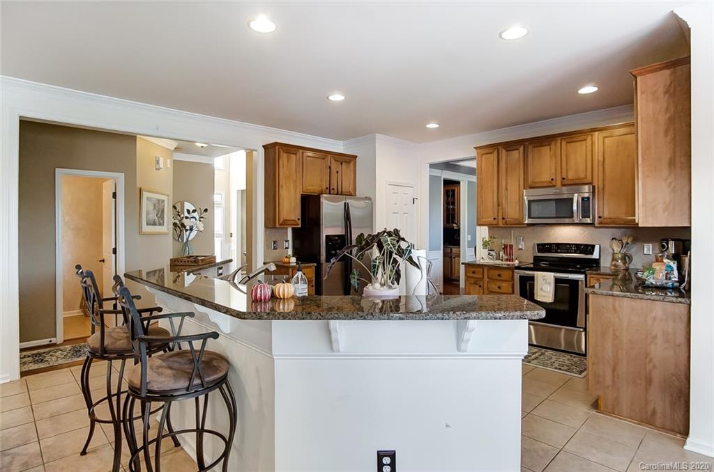 785 Fairway Point Drive Tega Cay, SC 29708 - Photo 12 of 46 a view of a kitchen with kitchen island granite countertop lots of counter top space and stainless steel appliances