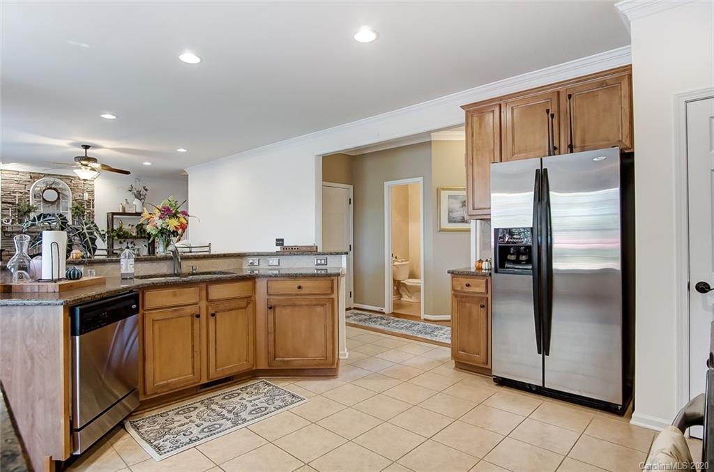 785 Fairway Point Drive Tega Cay, SC 29708 - Photo 15 of 46 a kitchen with stainless steel appliances granite countertop a refrigerator and a sink