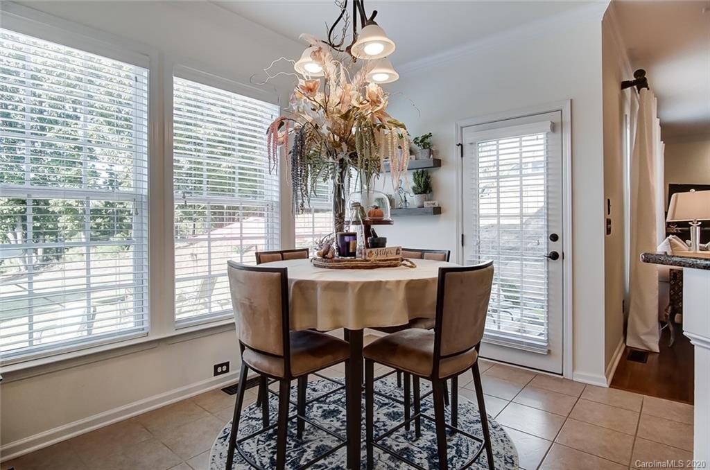 785 Fairway Point Drive Tega Cay, SC 29708 - Photo 16 of 46 a dining room with furniture a chandelier and window