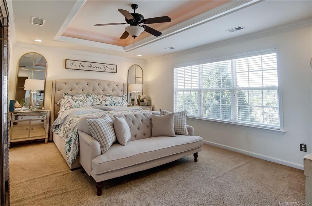 785 Fairway Point Drive Tega Cay, SC 29708 - Photo 19 of 46 a bedroom with a bed couch and window