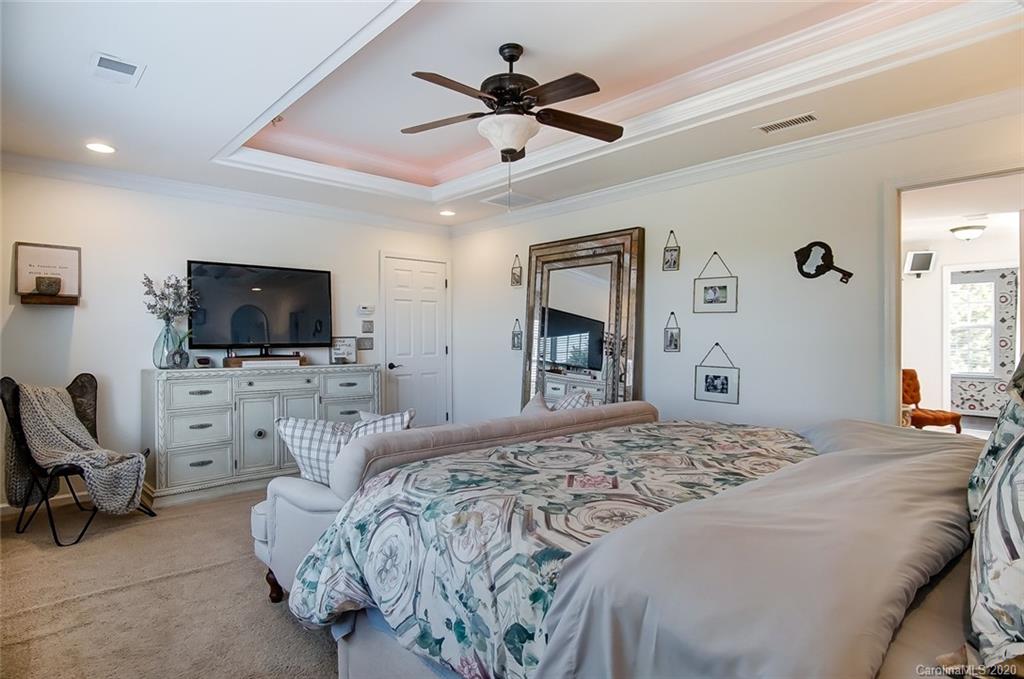 785 Fairway Point Drive Tega Cay, SC 29708 - Photo 20 of 46 a bedroom with a bed and a flat screen tv